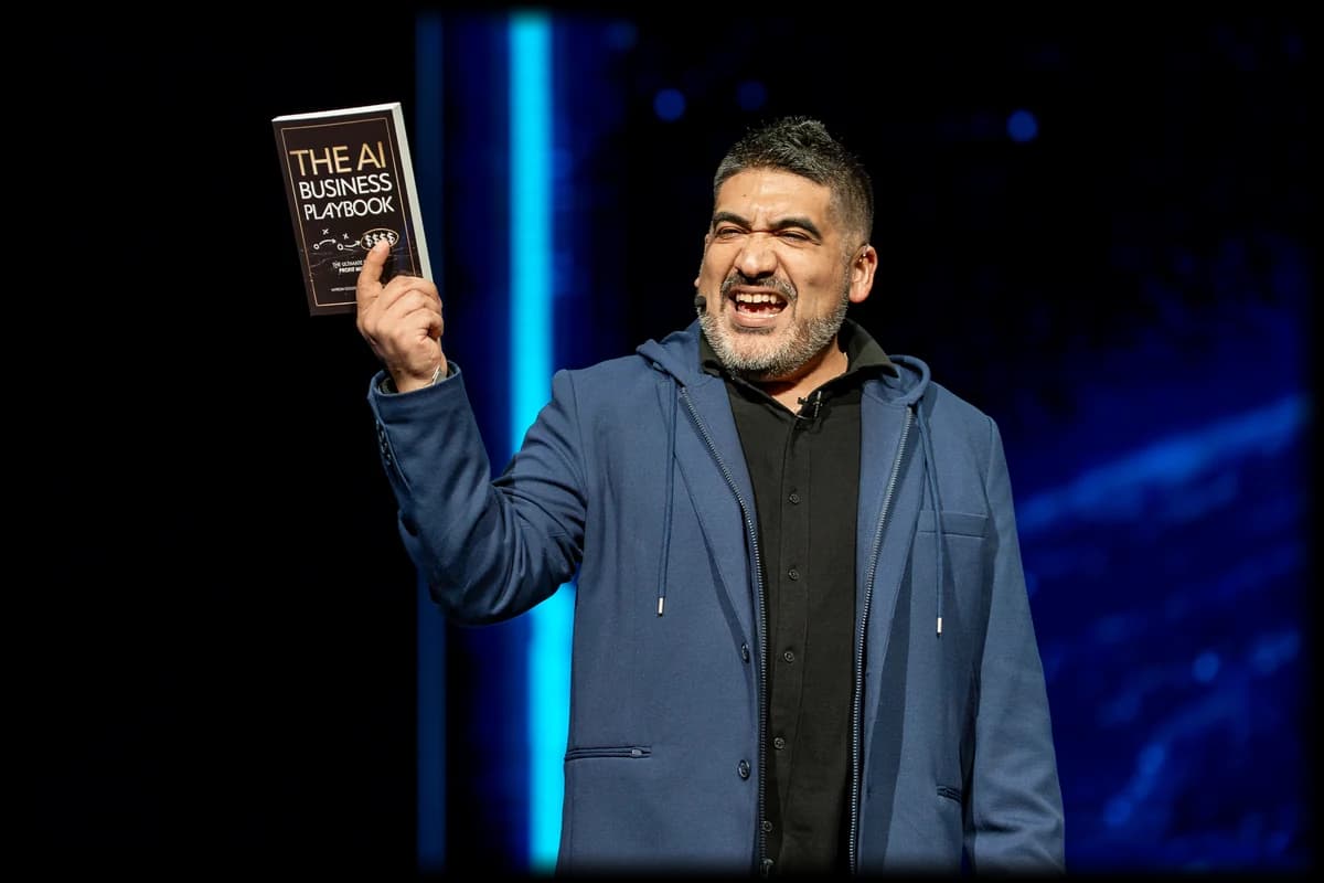 Miguel Carrasco holding up a copy of The AI Business Playbook