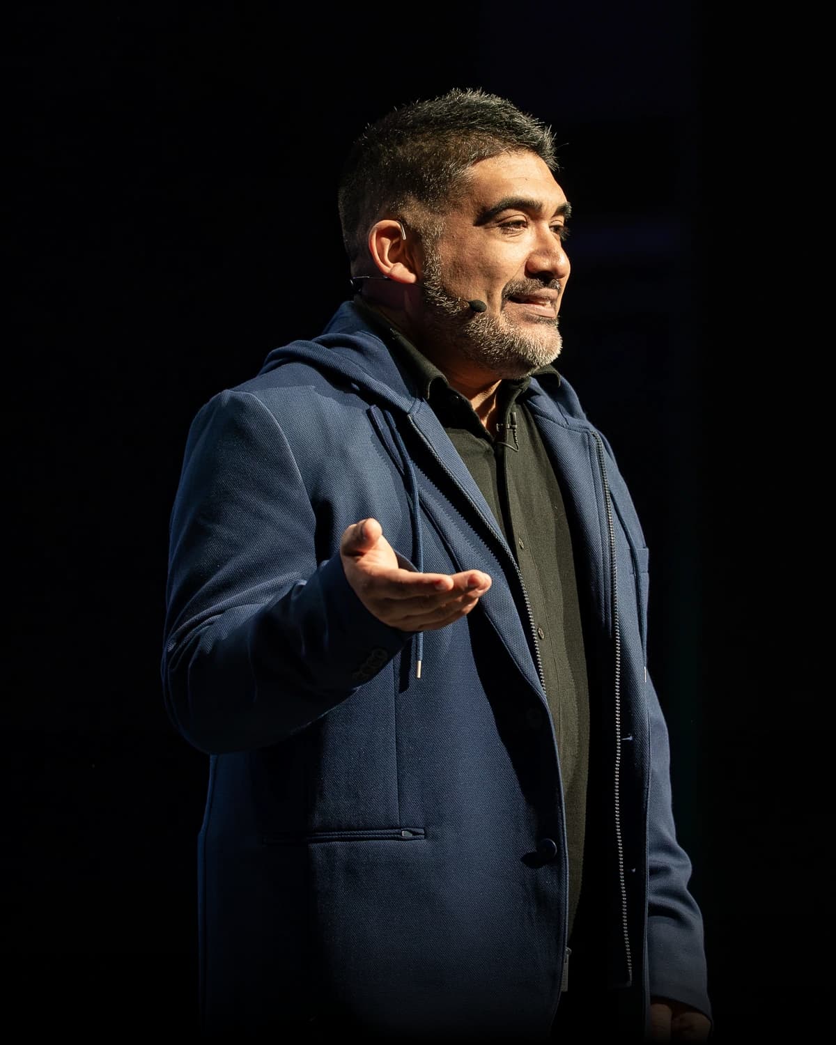 Miguel Carrasco speaking with a headset mic, close portrait